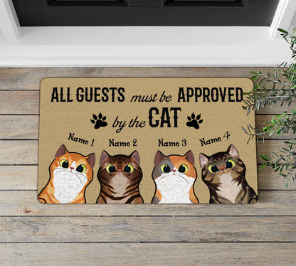 Doormat with cat-themed design and text on a wooden floor.