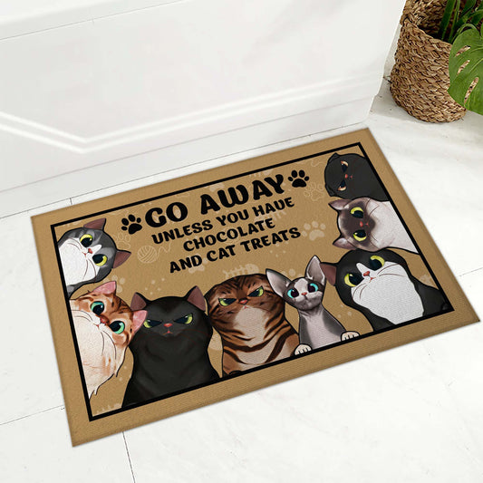 Doormat with cartoon cats and text 'Go away unless you have chocolate and cat treats' on a white floor.